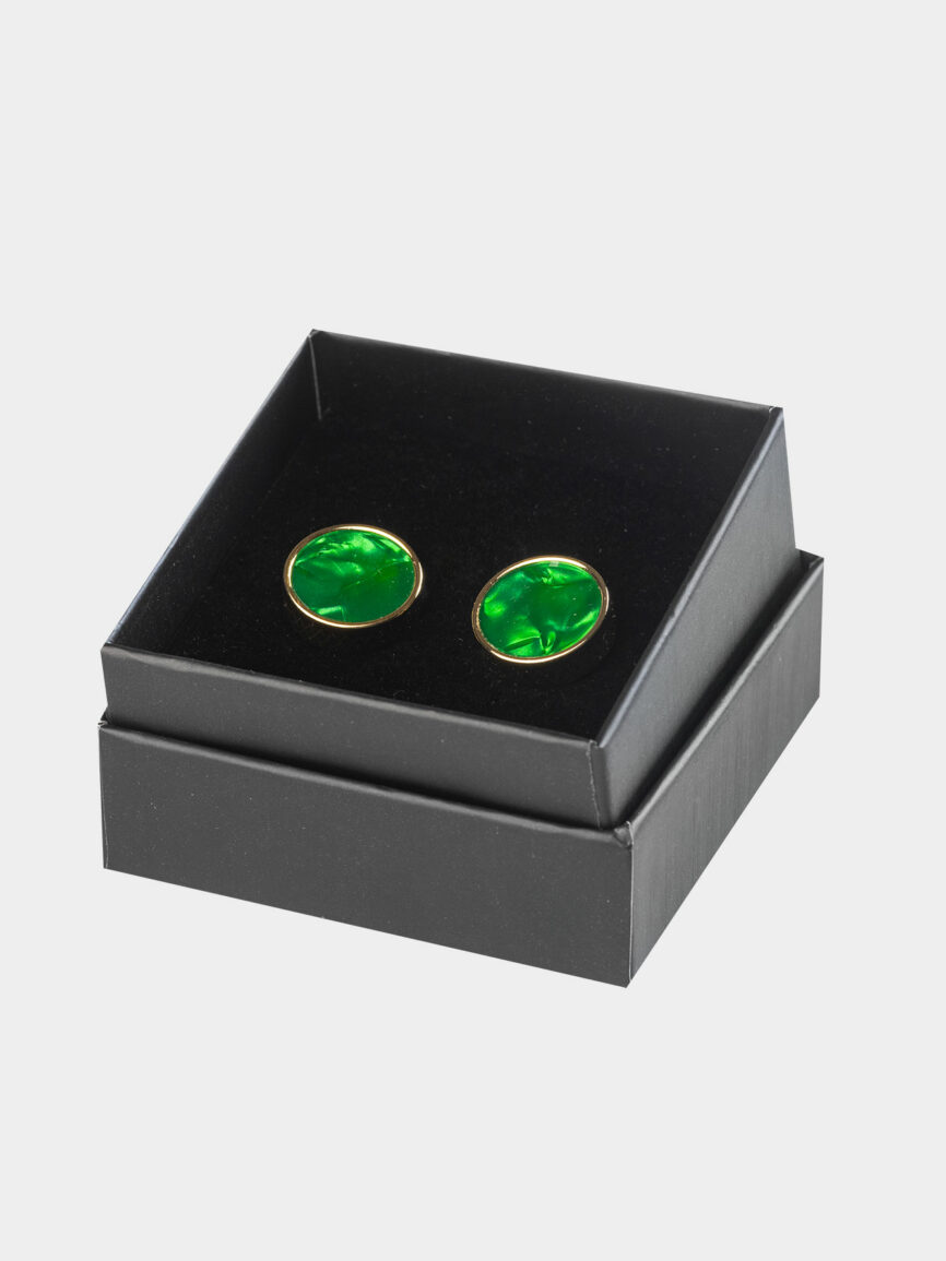 Gold-colored circular cufflinks with emerald green stone
